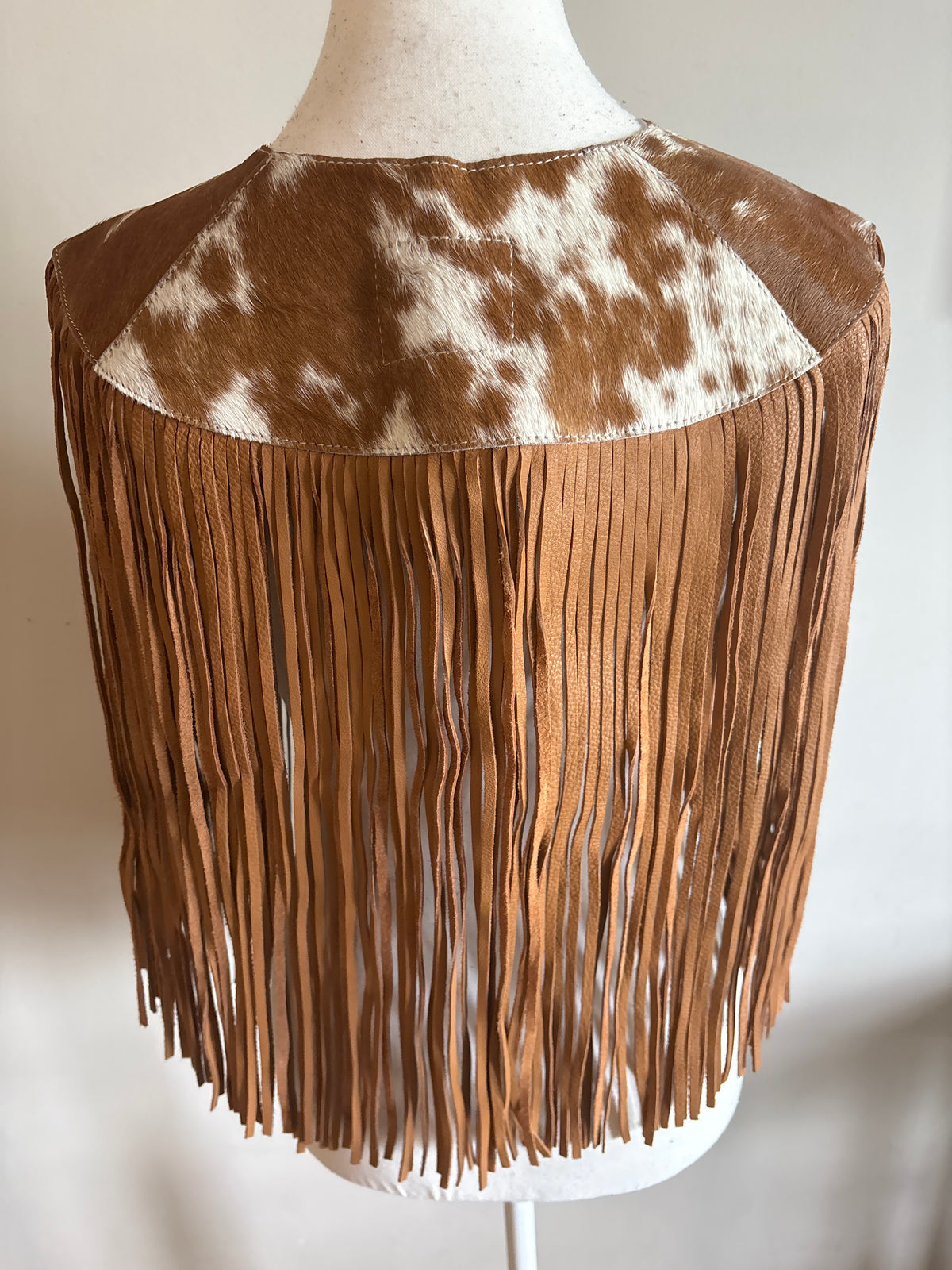 The fringe cape in tan