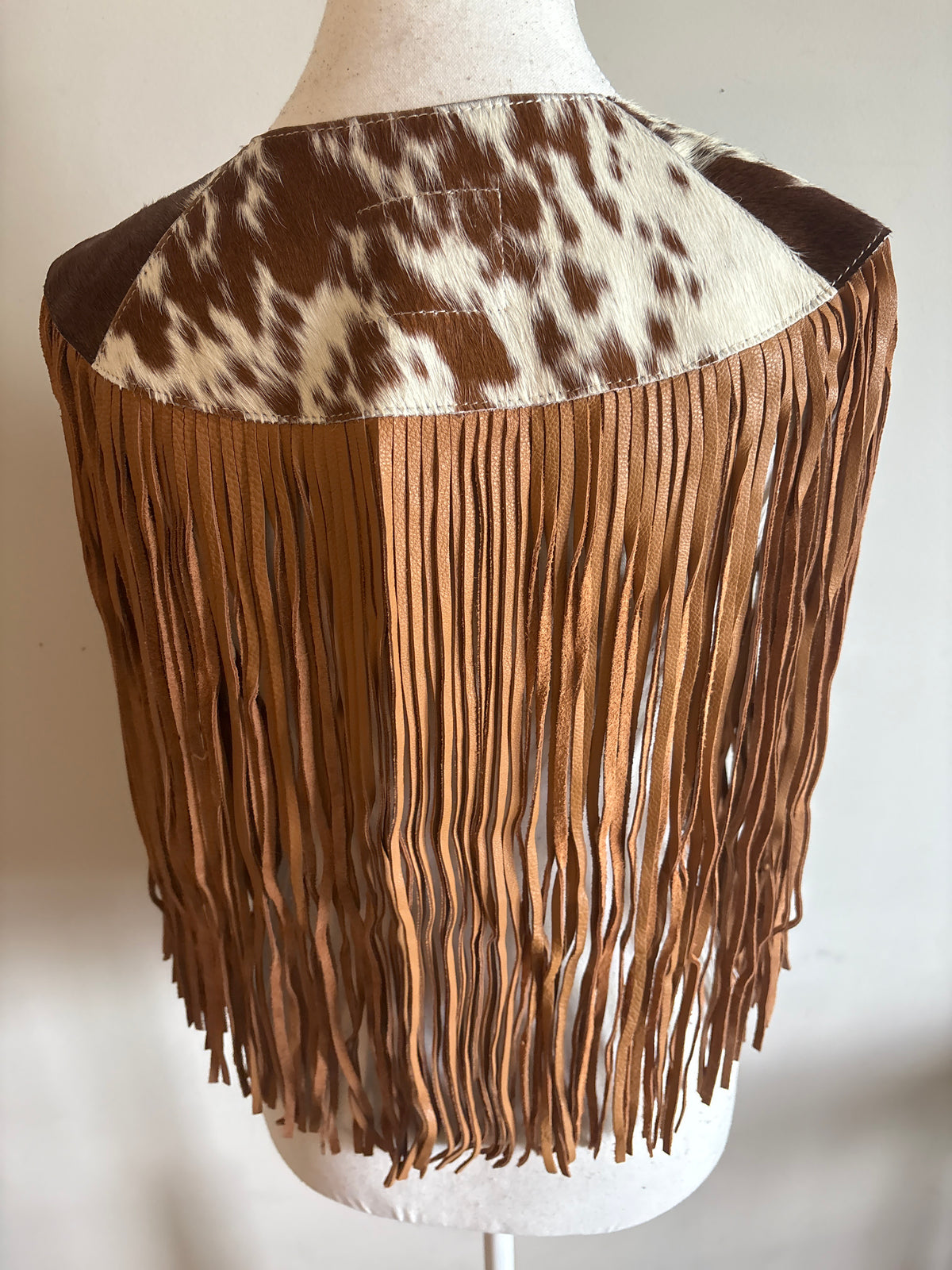 The fringe cape in tan
