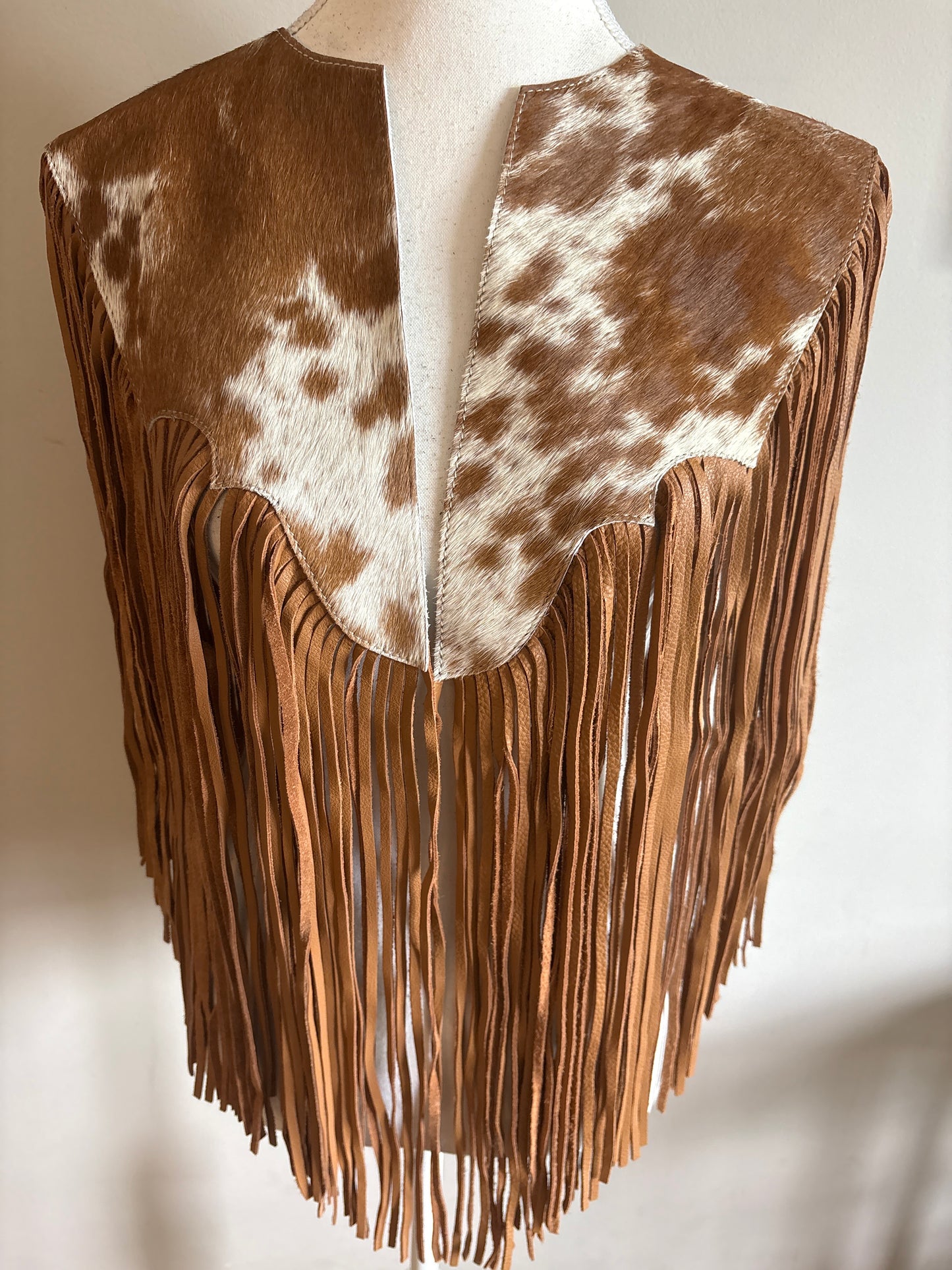The fringe cape in tan