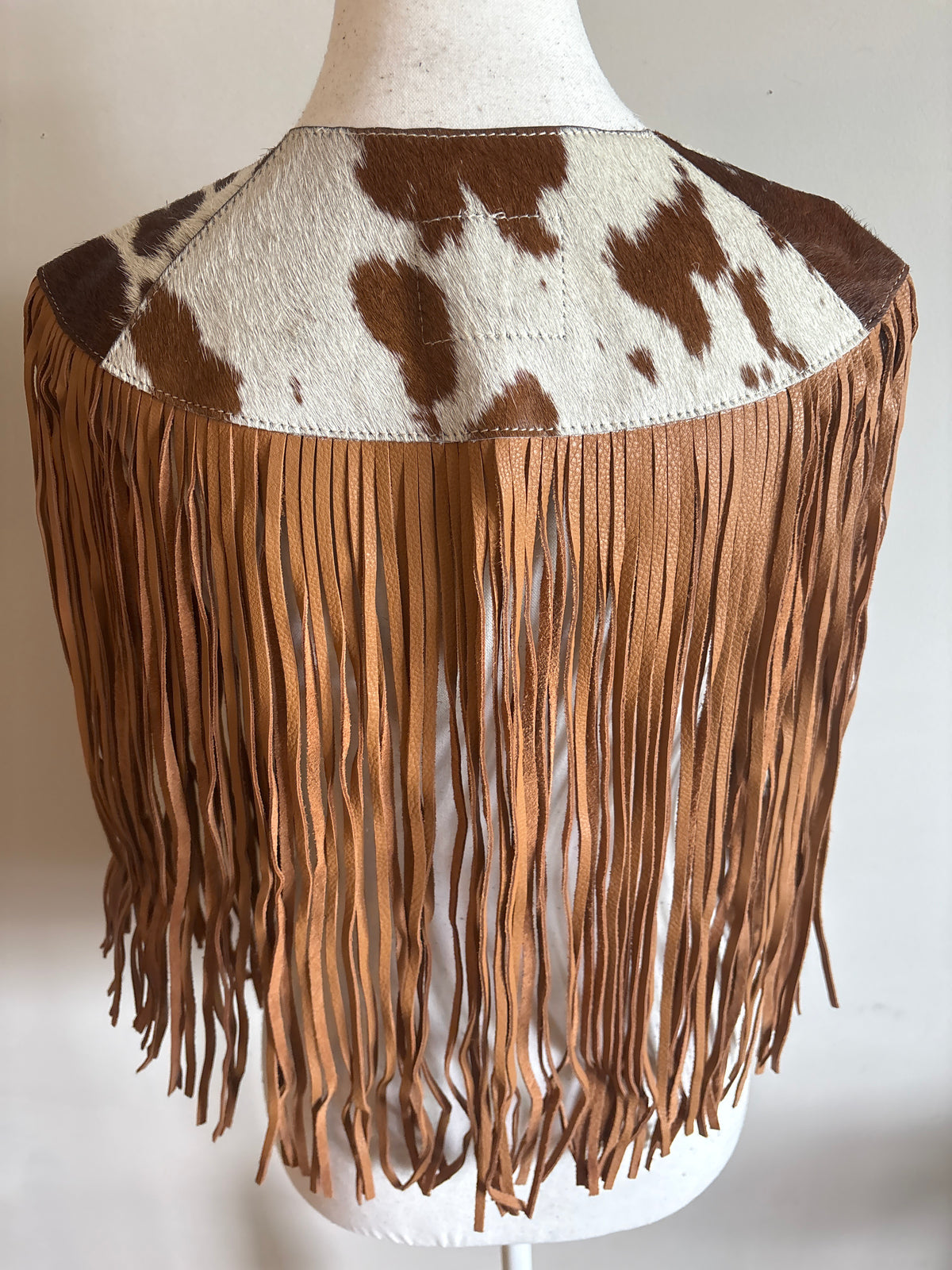 The fringe cape in tan