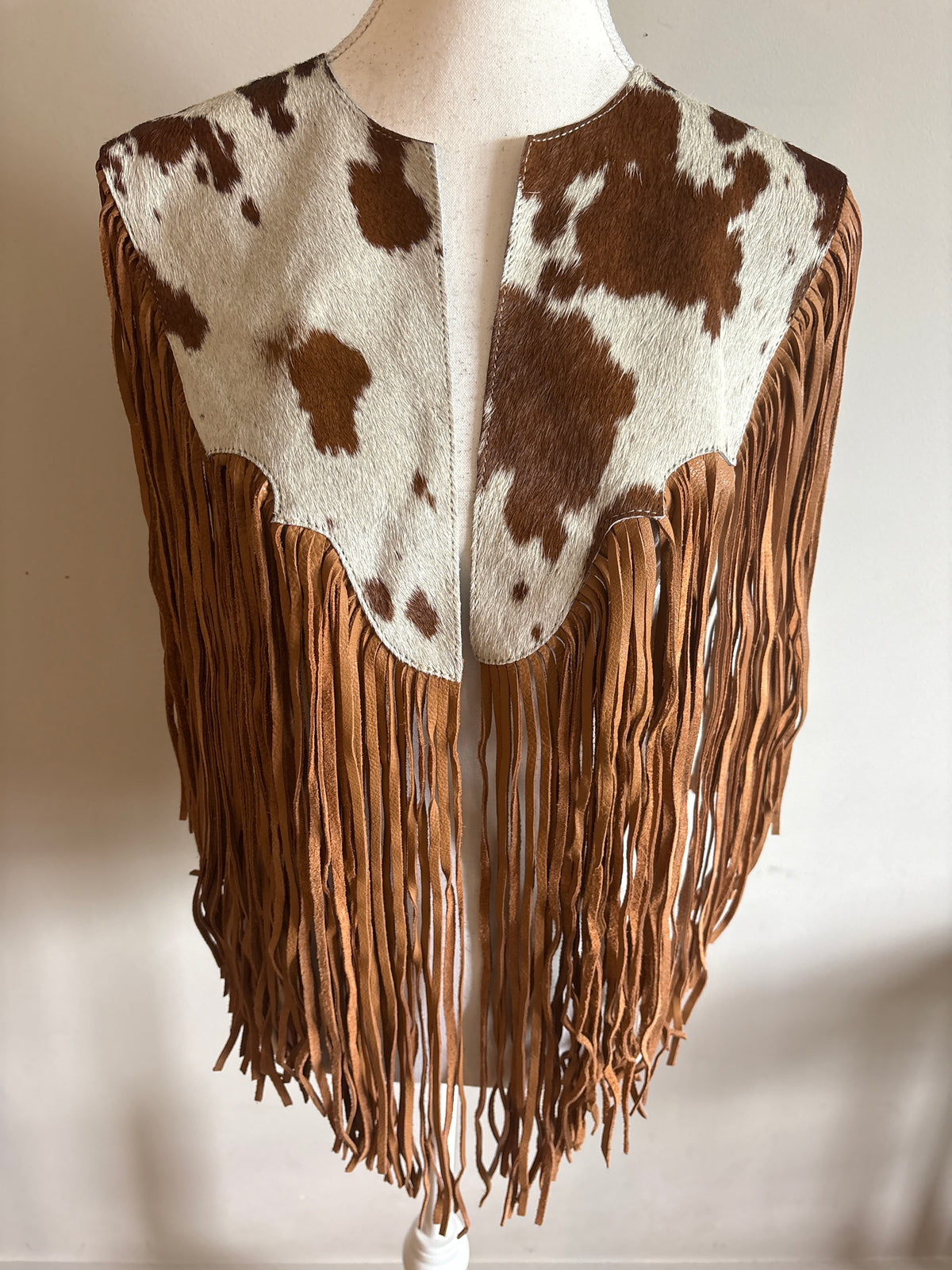 The fringe cape in tan
