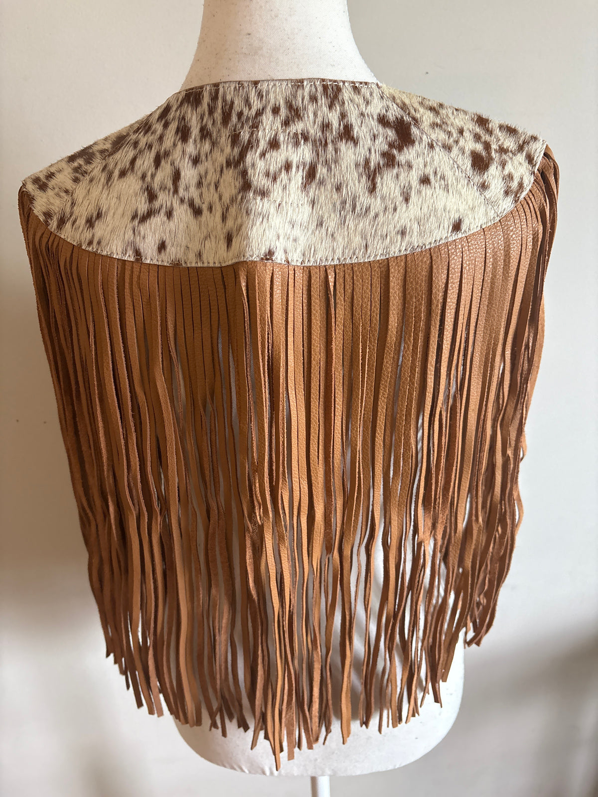 The fringe cape in tan