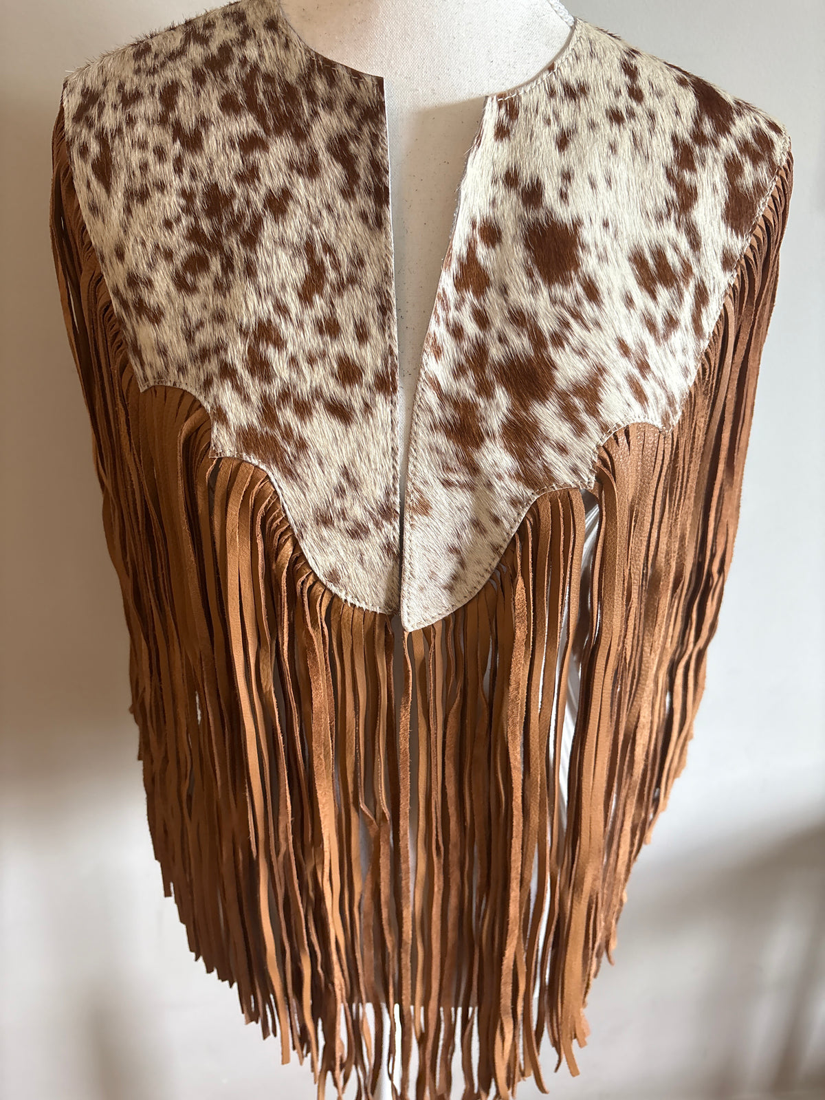 The fringe cape in tan