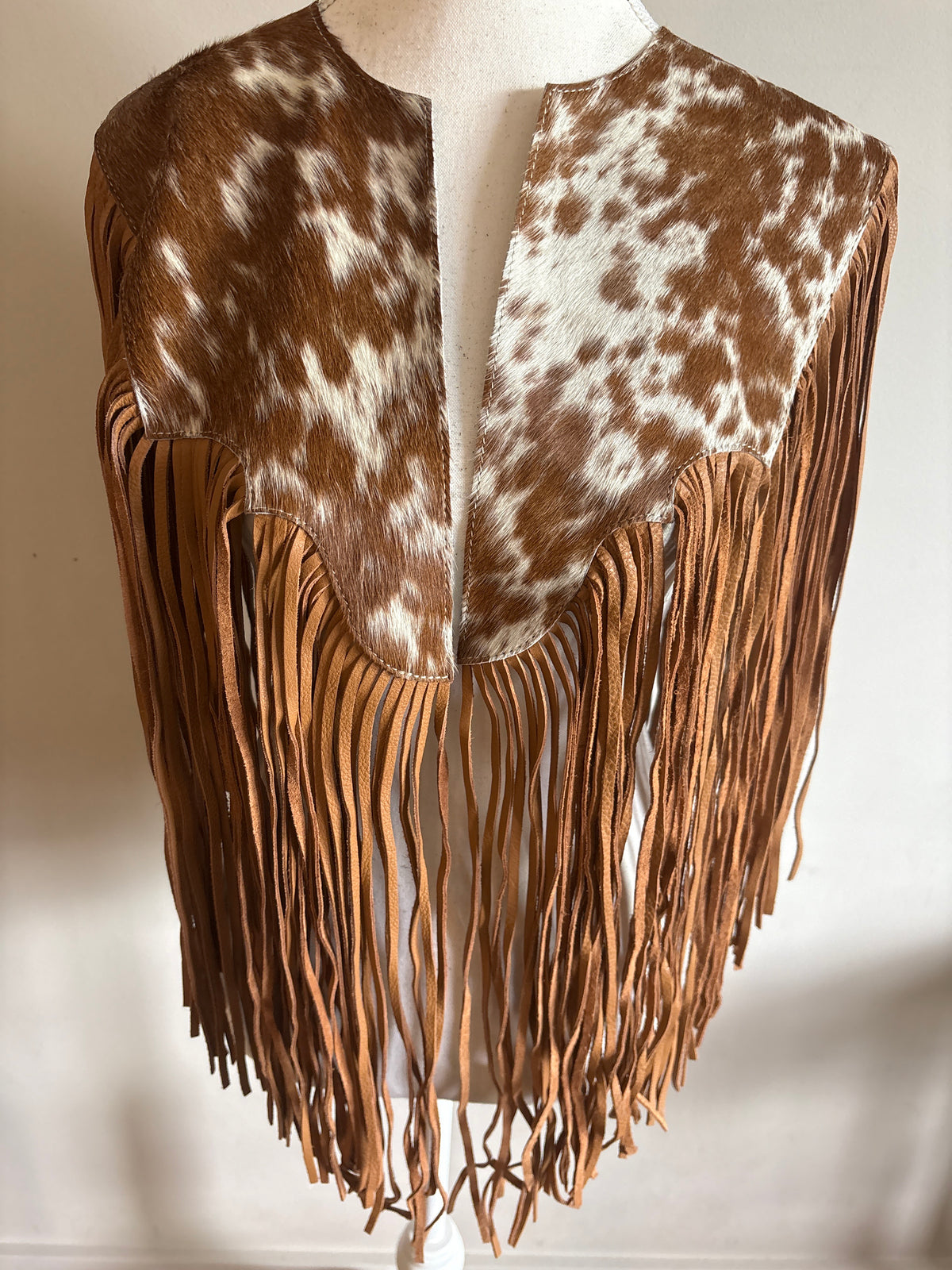 The fringe cape in tan