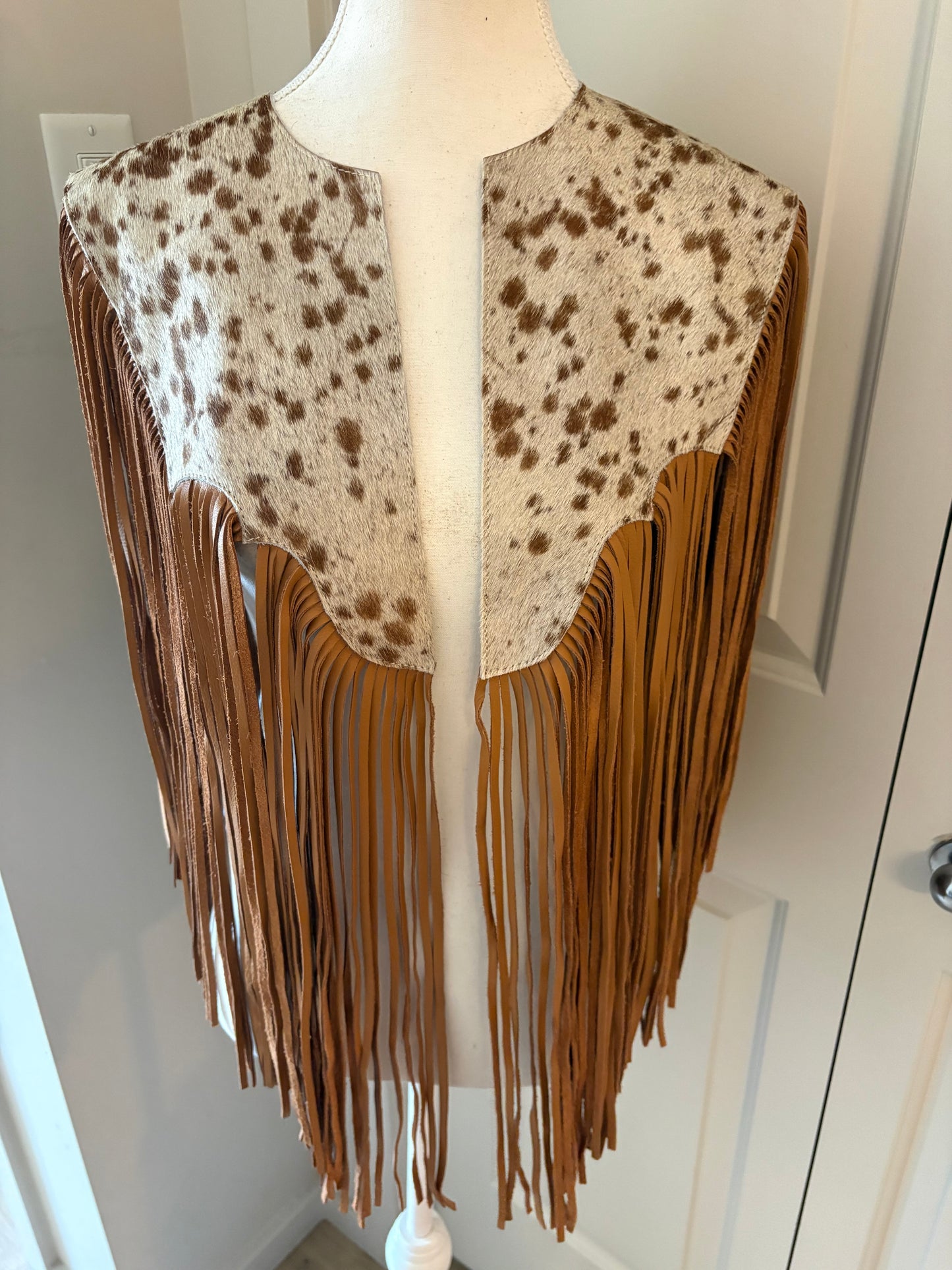 The fringe cape in tan