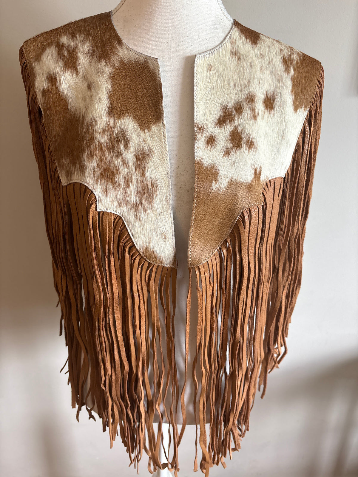 The fringe cape in tan