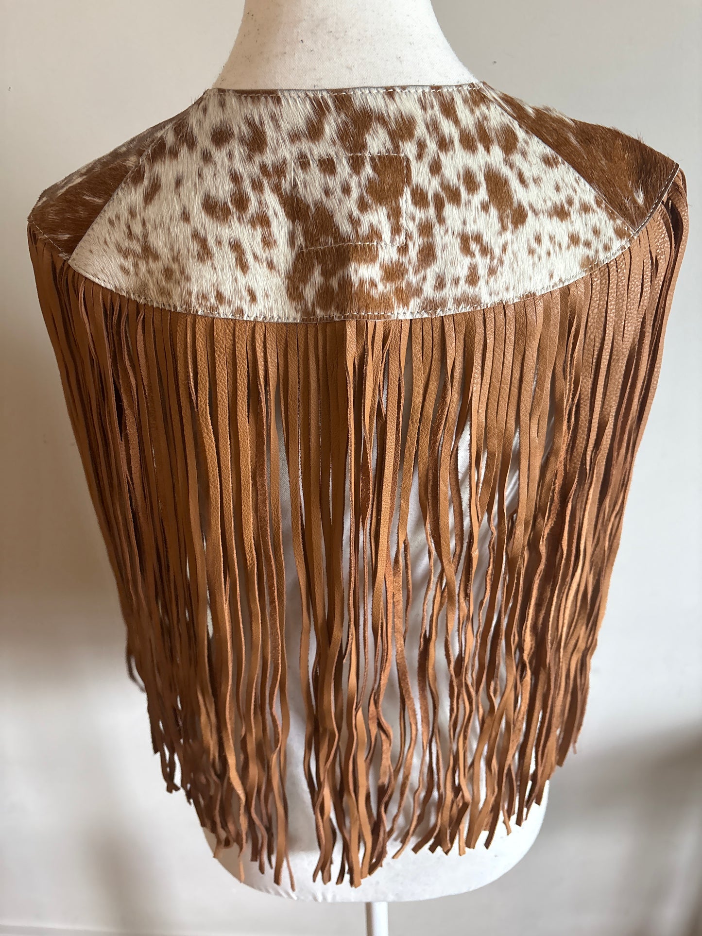 The fringe cape in tan