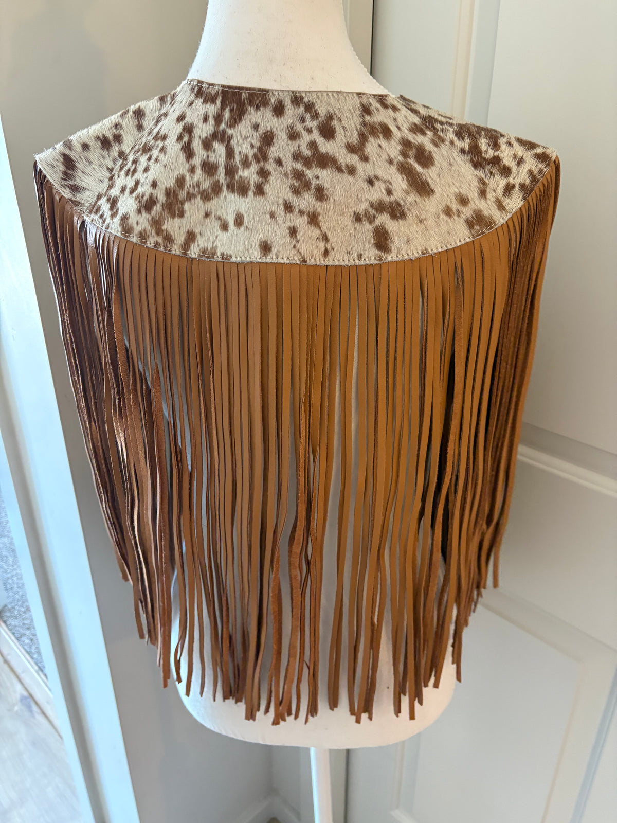 The fringe cape in tan